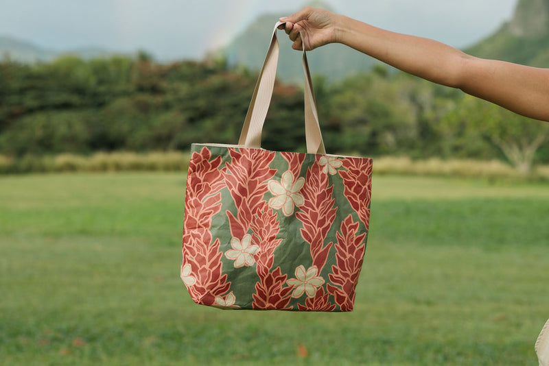 Woman with tote bag with red ginger flowers and beige tiare flower print.