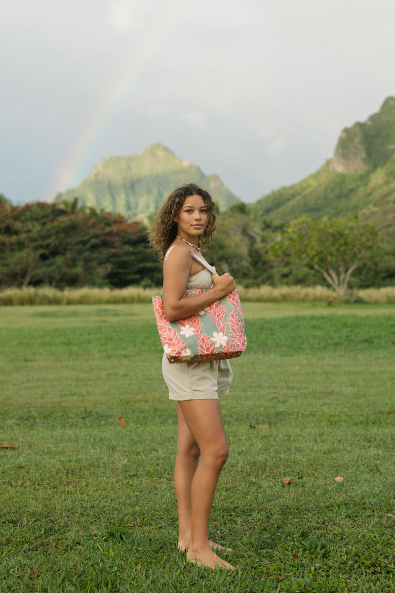 Woman with tote bag with red ginger flowers and beige tiare flower print.