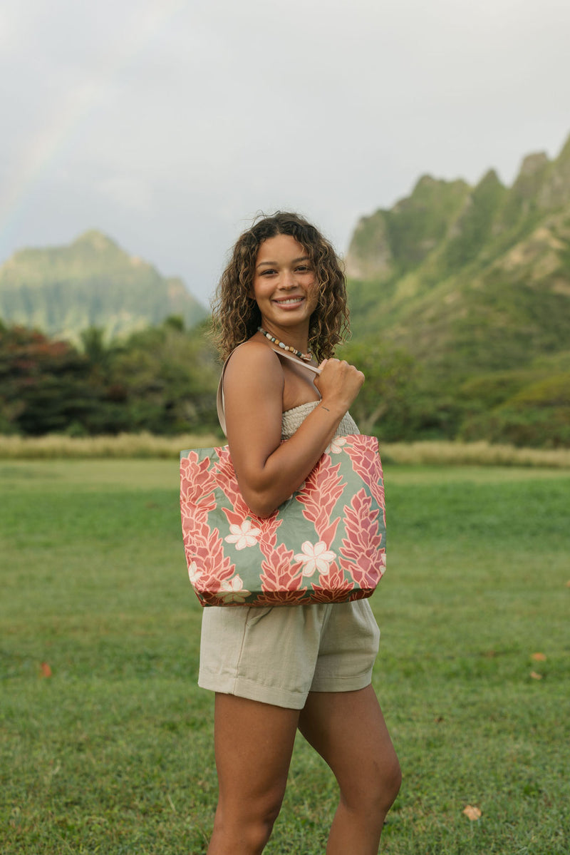 Woman with tote bag with red ginger flowers and beige tiare flower print.