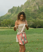 Woman with tote bag with red ginger flowers and beige tiare flower print.