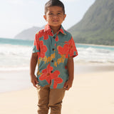 little boy wearing a green button up shirt with orange and yellow lei pua print