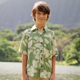 little boy wearing green aloha shirt with native Hawaiian plants