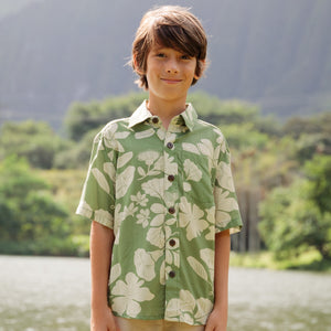 little boy wearing green aloha shirt with native Hawaiian plants