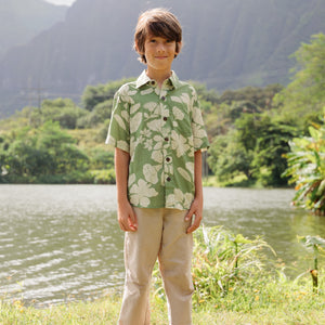 little boy wearing green aloha shirt with native Hawaiian plants