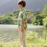 little boy wearing green aloha shirt with native Hawaiian plants