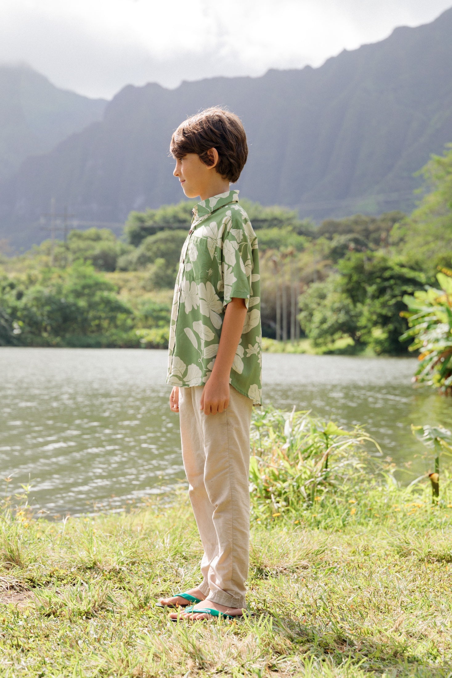 little boy wearing green aloha shirt with native Hawaiian plants