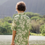 little boy wearing green aloha shirt with native Hawaiian plants