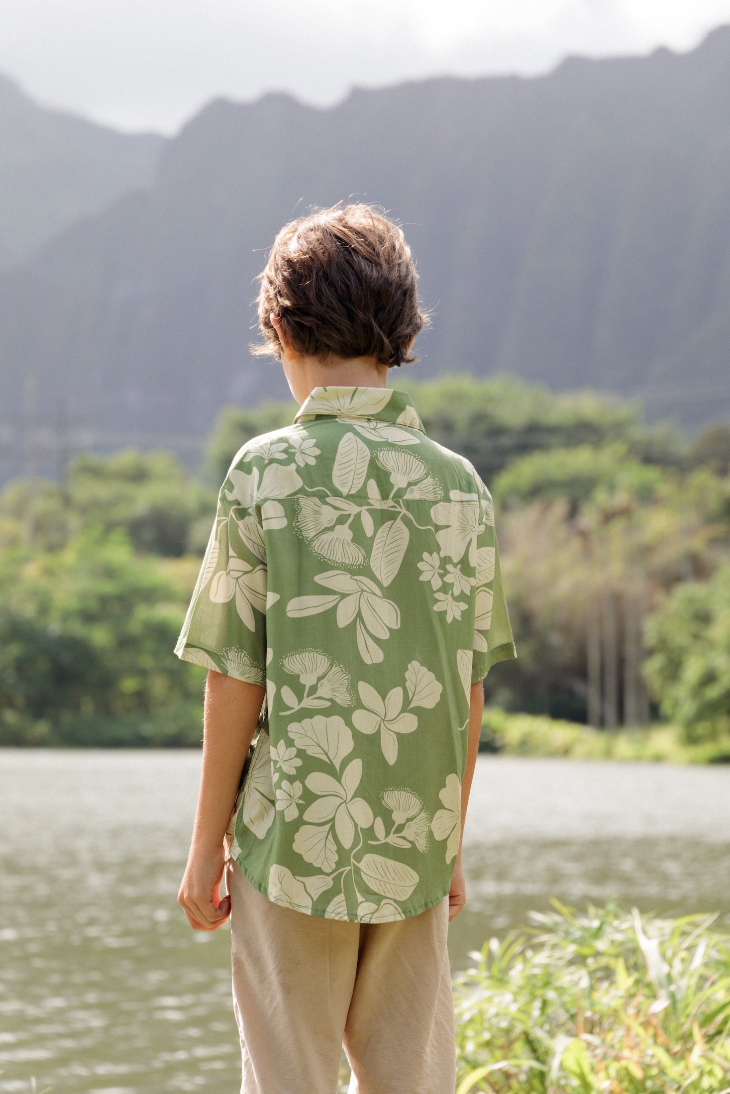 little boy wearing green aloha shirt with native Hawaiian plants