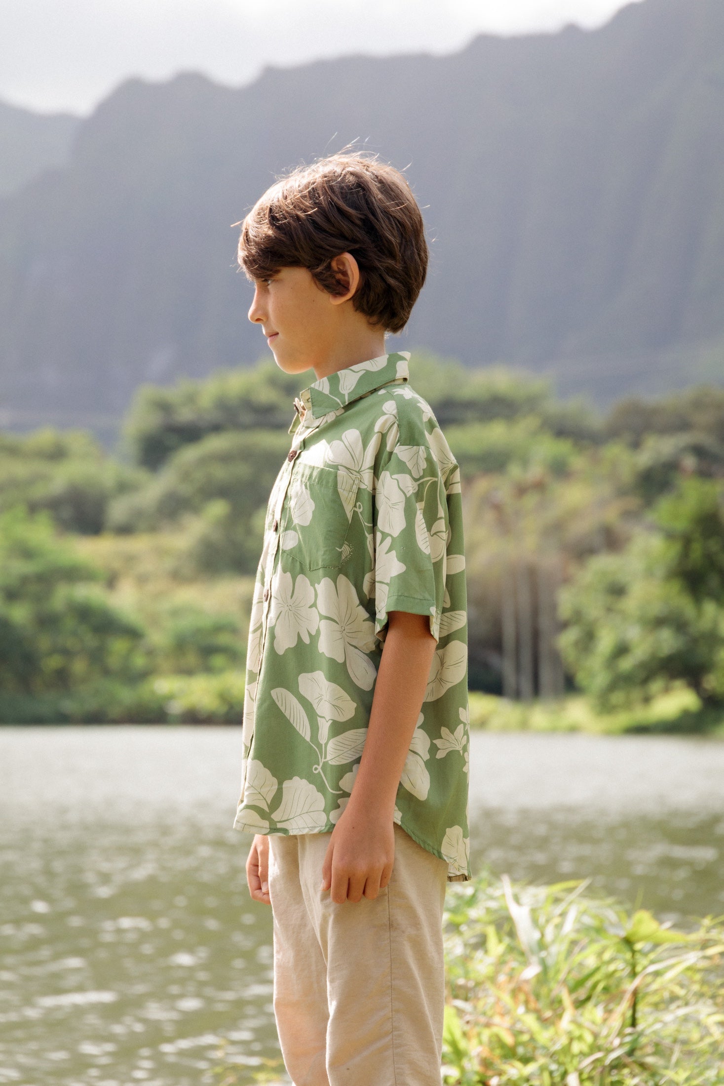 little boy wearing green aloha shirt with native Hawaiian plants