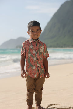 little boy wearing jade colored aloha button up with tiare ginger print