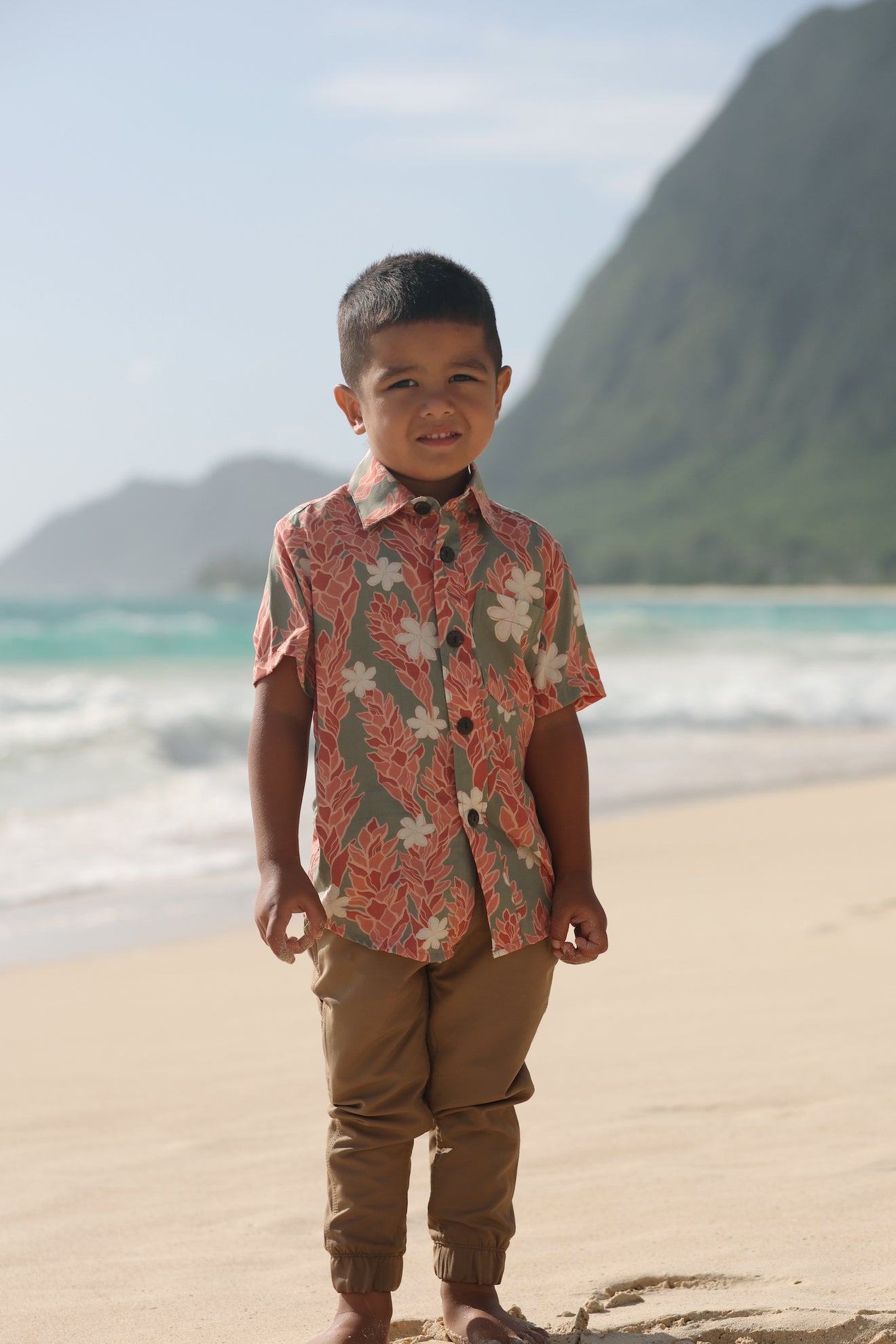 little boy wearing jade colored aloha button up with tiare ginger print