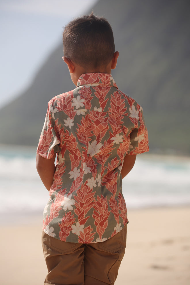 little boy wearing jade colored aloha button up with tiare ginger print