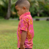 little boy wearing a mini aloha button up shirt in pink with lei pattern
