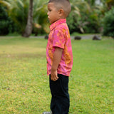 little boy wearing a mini aloha button up shirt in pink with lei pattern
