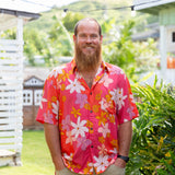 man wearing pink aloha button up shirt with retro flower pattern