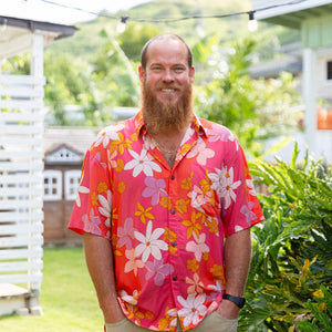 man wearing pink aloha button up shirt with retro flower pattern