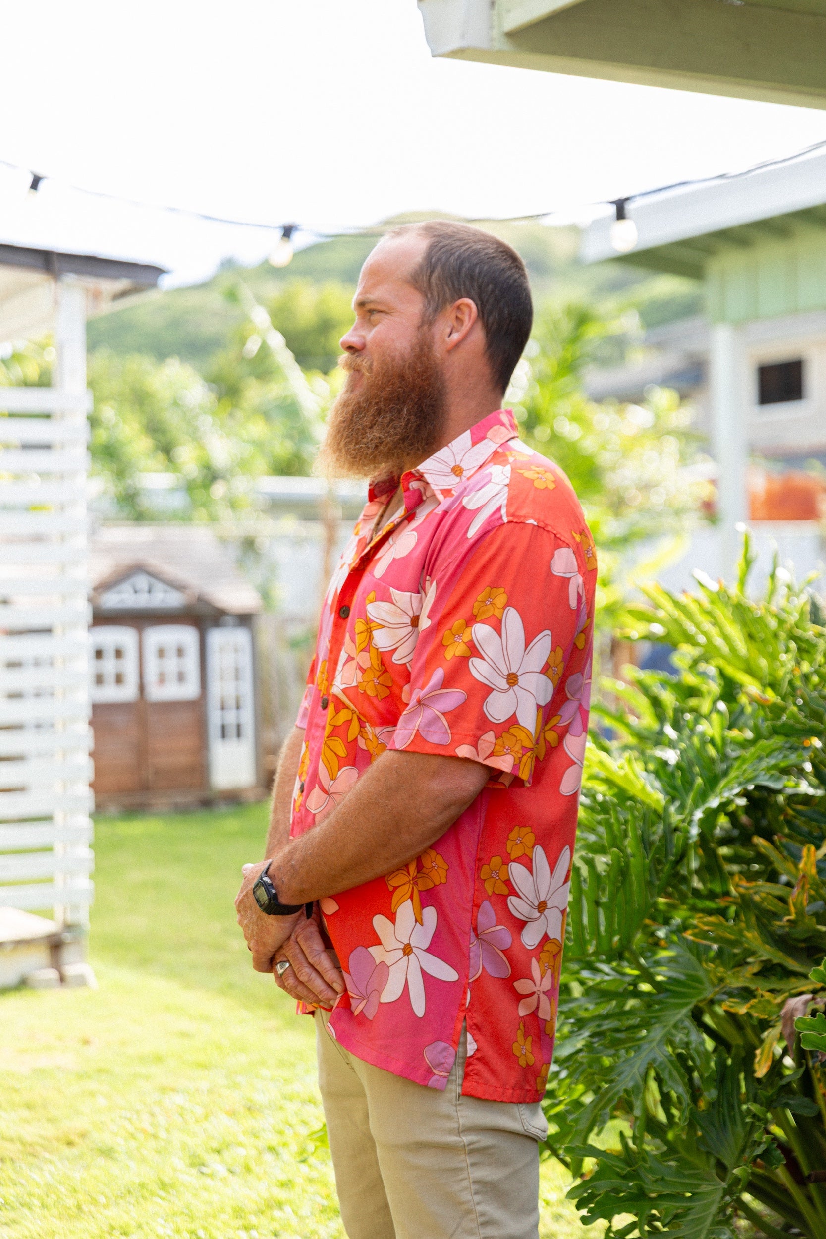 man wearing pink aloha button up shirt with retro flower pattern