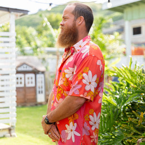 man wearing pink aloha button up shirt with retro flower pattern
