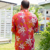 man wearing pink aloha button up shirt with retro flower pattern