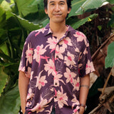 man wearing dark purple aloha shirt with orchid print
