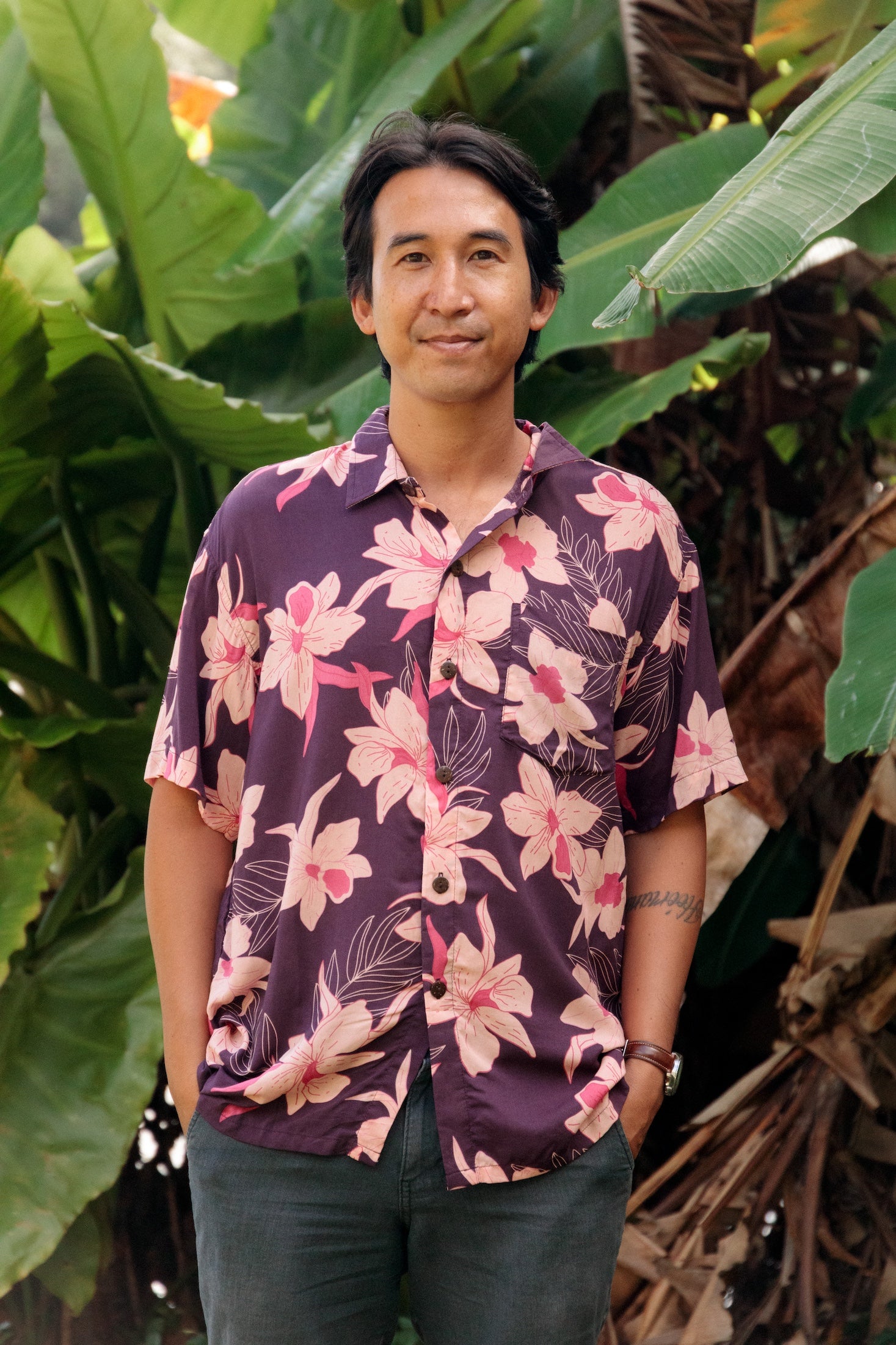 man wearing dark purple aloha shirt with orchid print