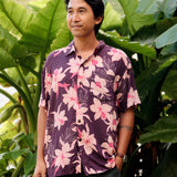 man wearing dark purple aloha shirt with orchid print