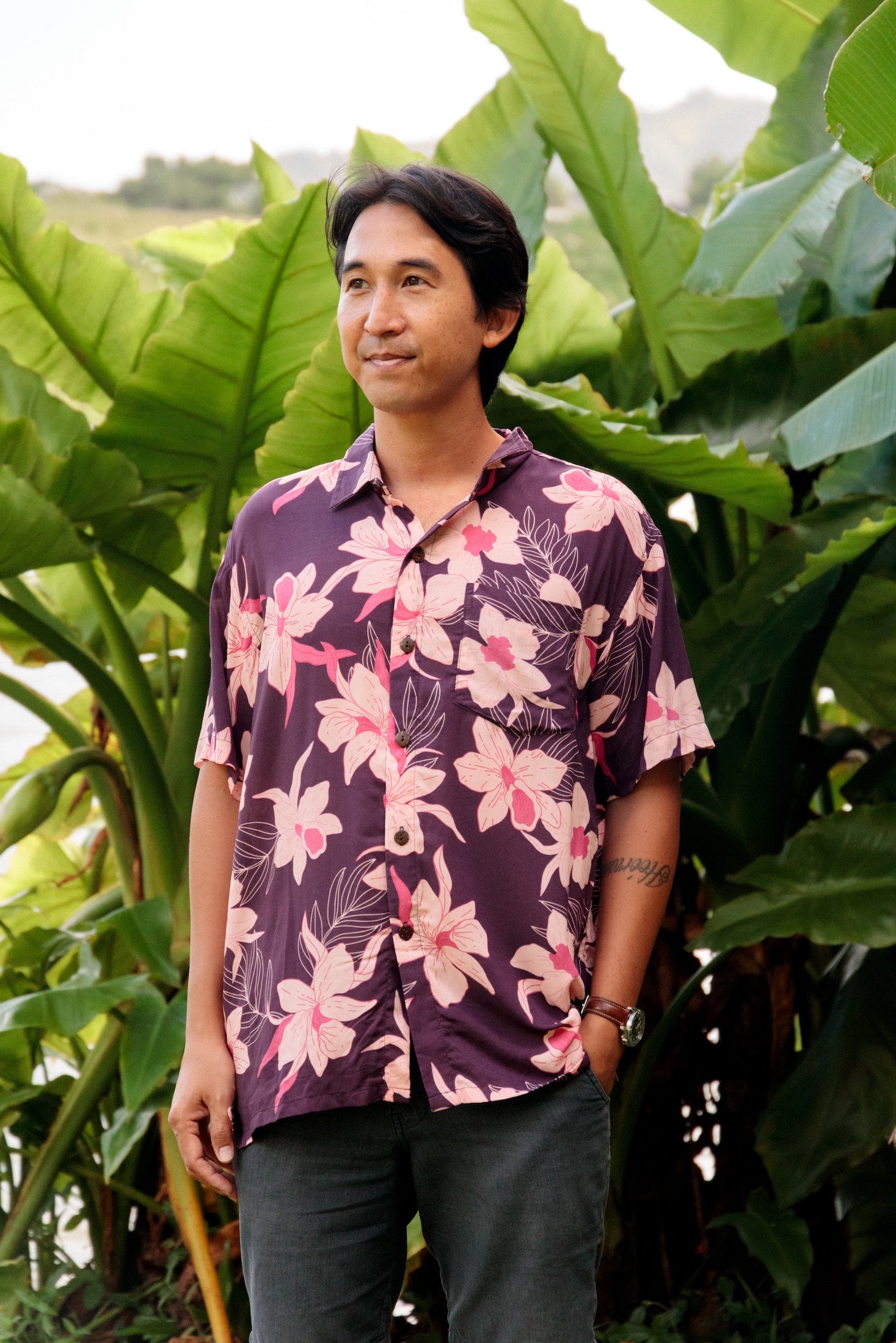 man wearing dark purple aloha shirt with orchid print