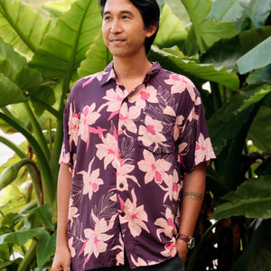 man wearing dark purple aloha shirt with orchid print