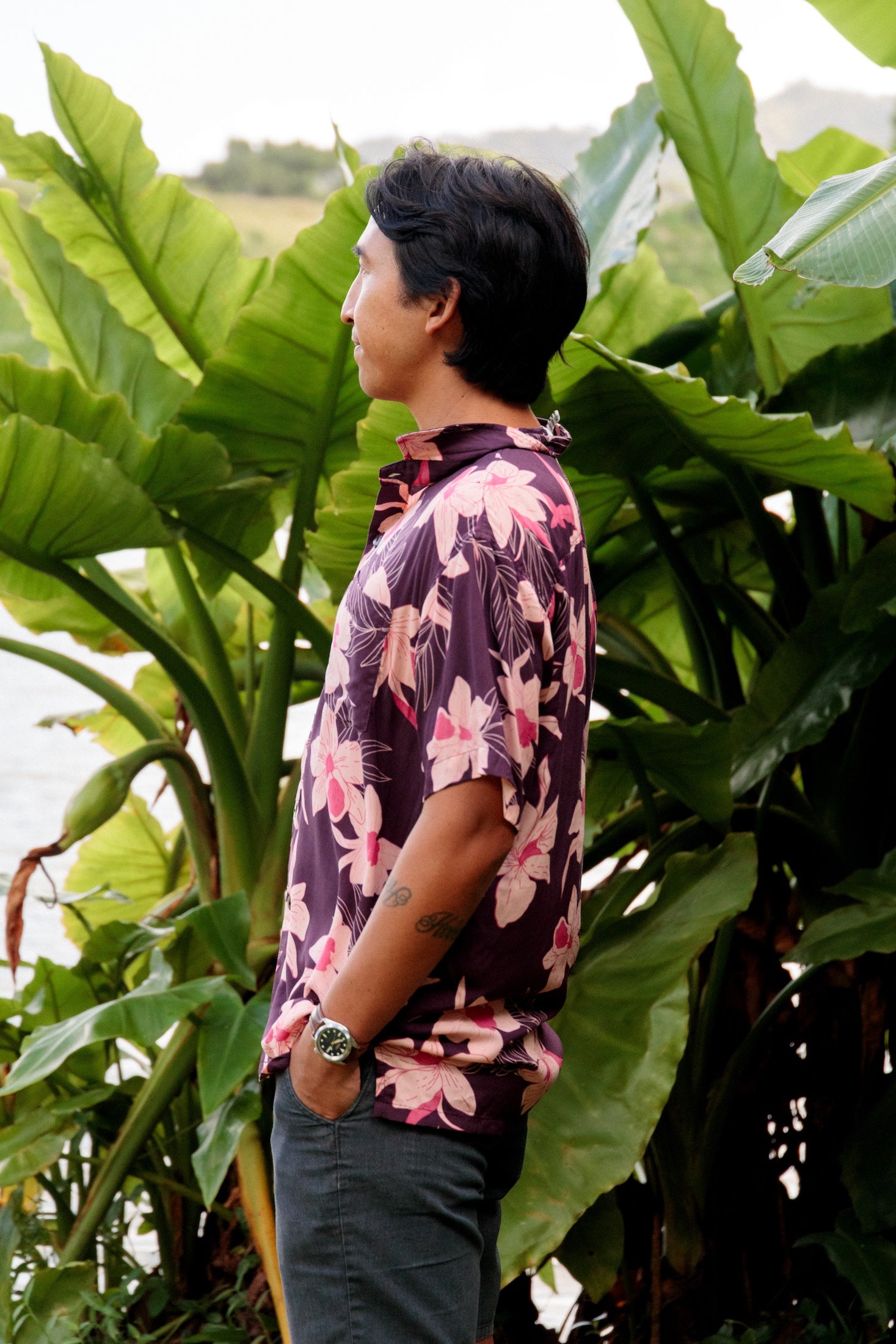 man wearing dark purple aloha shirt with orchid print
