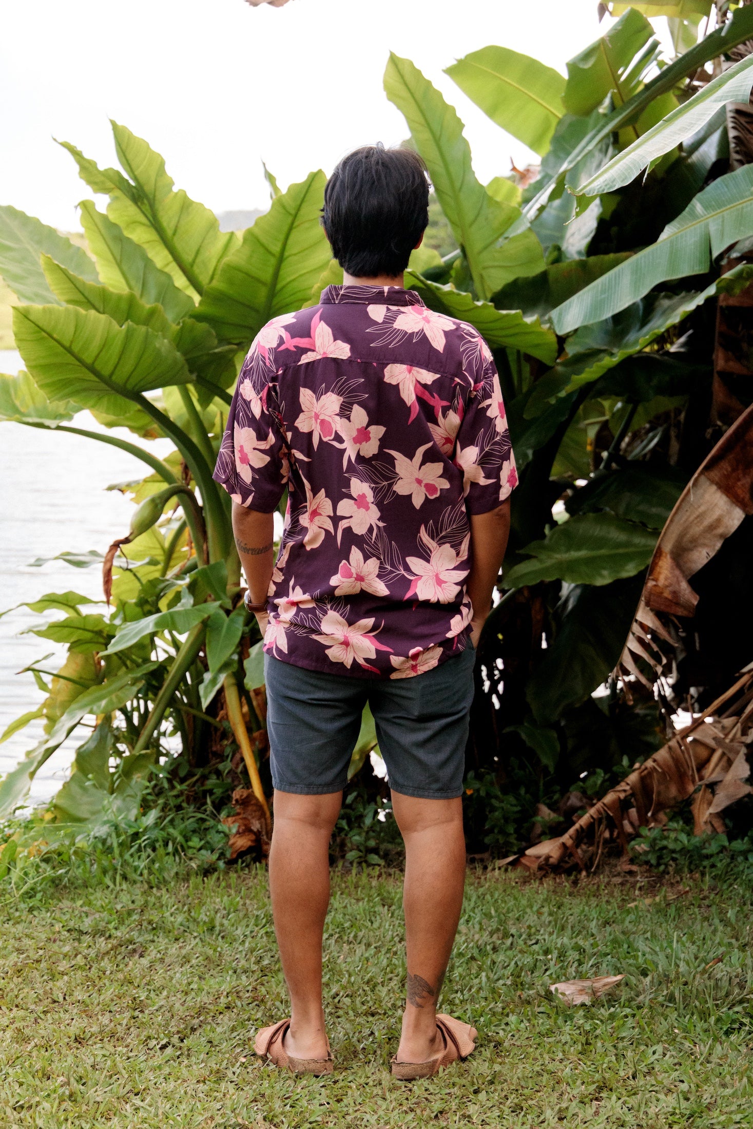 man wearing dark purple aloha shirt with orchid print