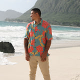 man wearing green button up shirt with lei pua print