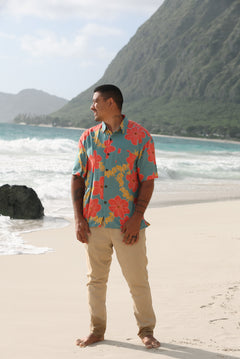 man wearing green button up shirt with lei pua print
