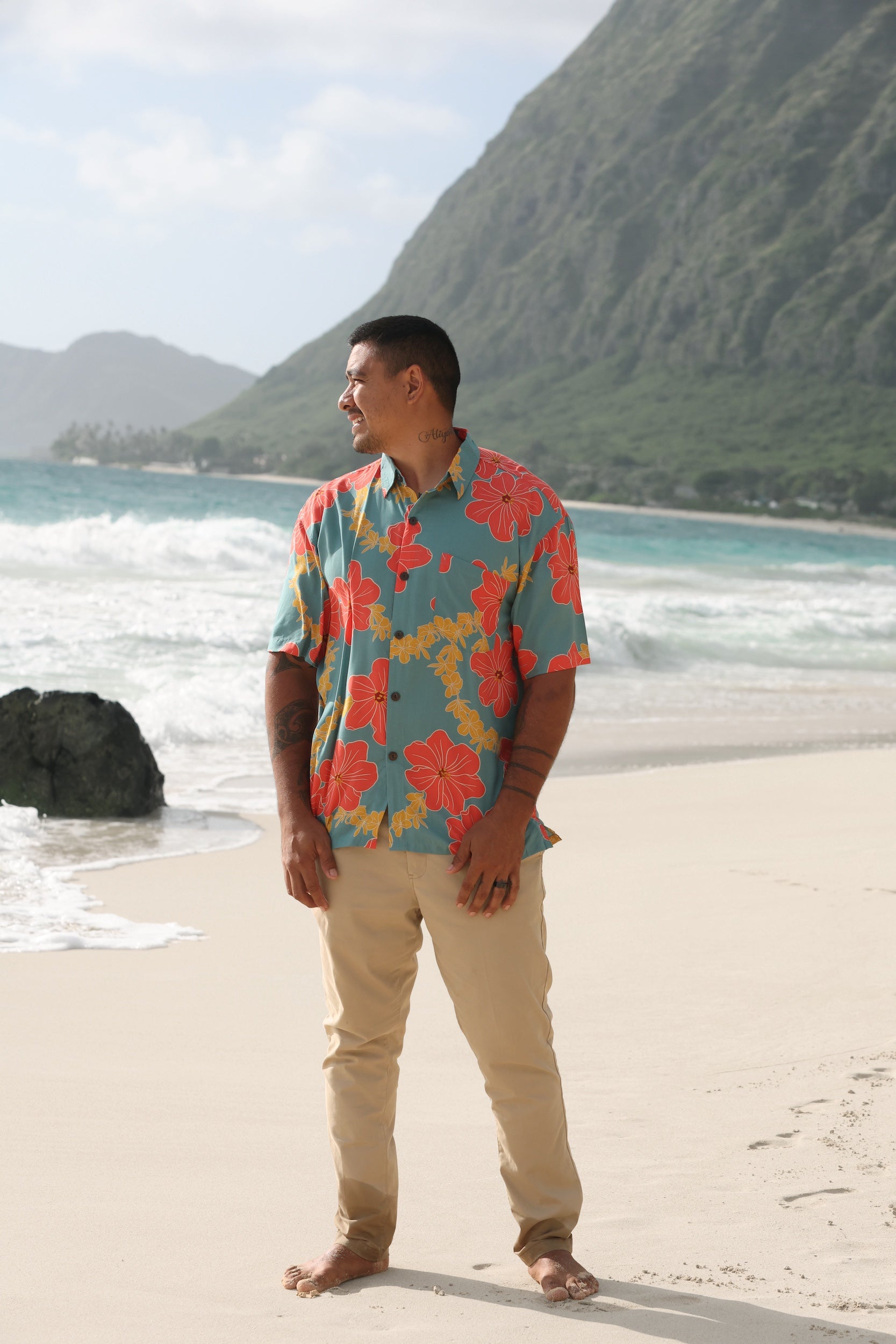 man wearing green button up shirt with lei pua print