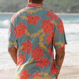 man wearing green button up shirt with orange and yellow lei pua print