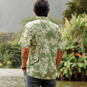 man wearing green aloha button up shirt with Native Hawaiian plant pattern