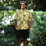 man wearing aloha button up shirt in green print with naupaka pattern