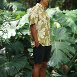 man wearing aloha button up shirt in green print with naupaka pattern