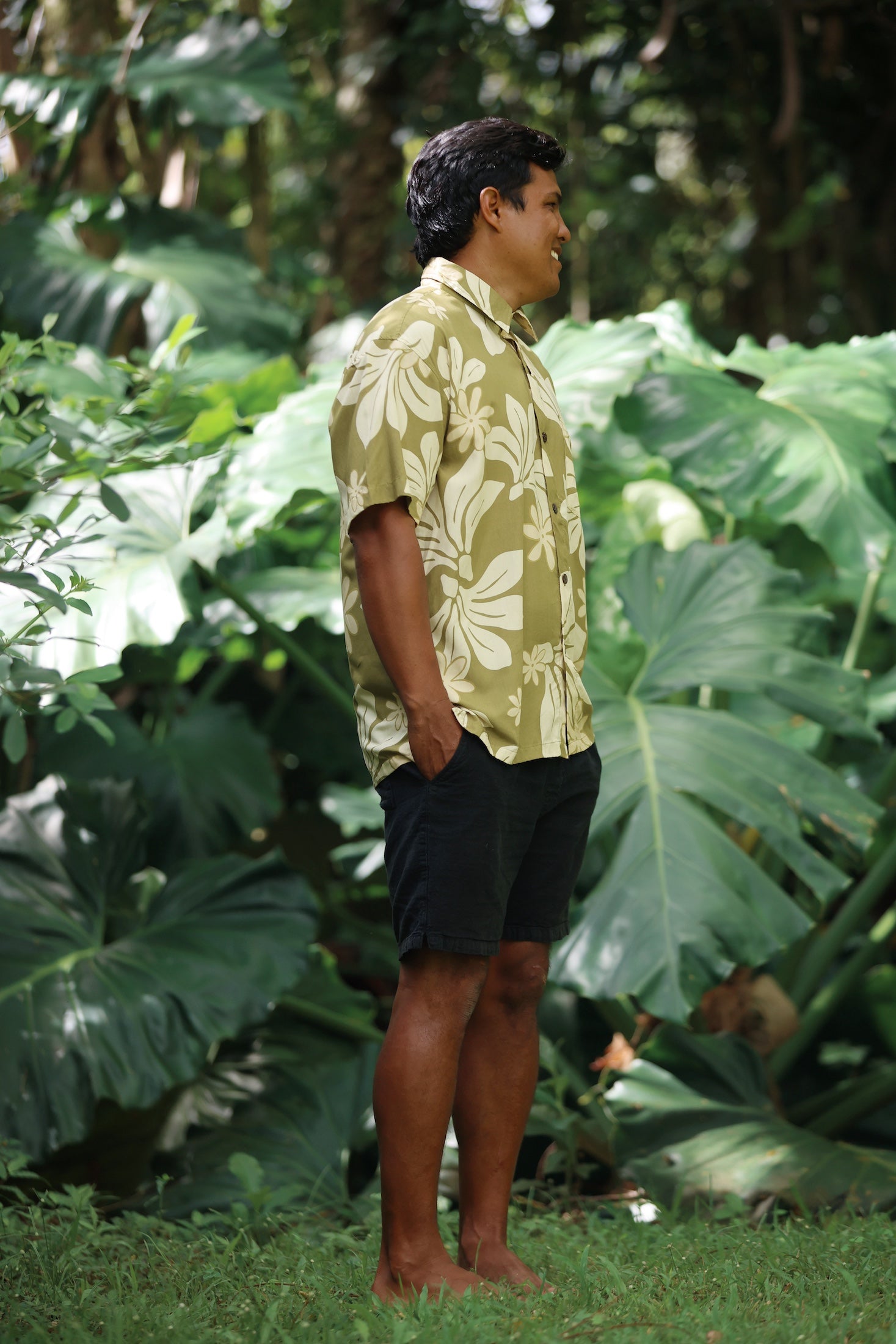 man wearing aloha button up shirt in green print with naupaka pattern