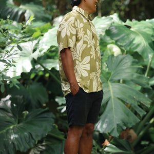 man wearing aloha button up shirt in green print with naupaka pattern