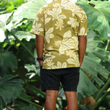 man wearing aloha button up shirt in green print with naupaka pattern