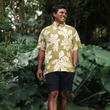 man wearing aloha button up shirt in green print with naupaka pattern