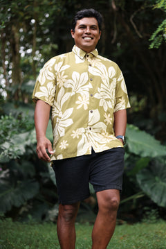 man wearing aloha button up shirt in green print with naupaka pattern
