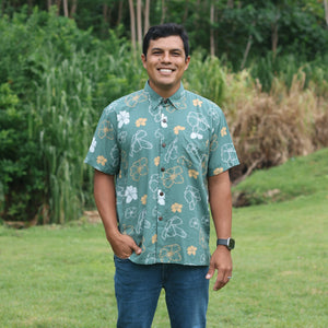 man wearing lush green aloha button-up shirt with pua kenikeni print