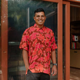 man wearing aloha shirt with vibrant pink pua pattern