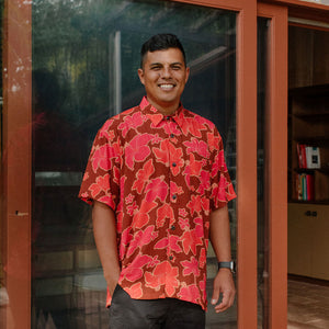man wearing aloha shirt with vibrant pink pua pattern