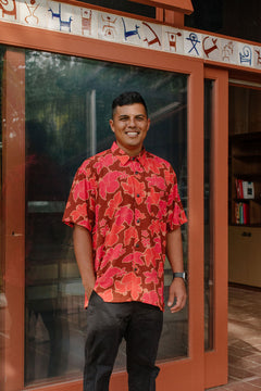 man wearing aloha shirt with vibrant pink pua pattern