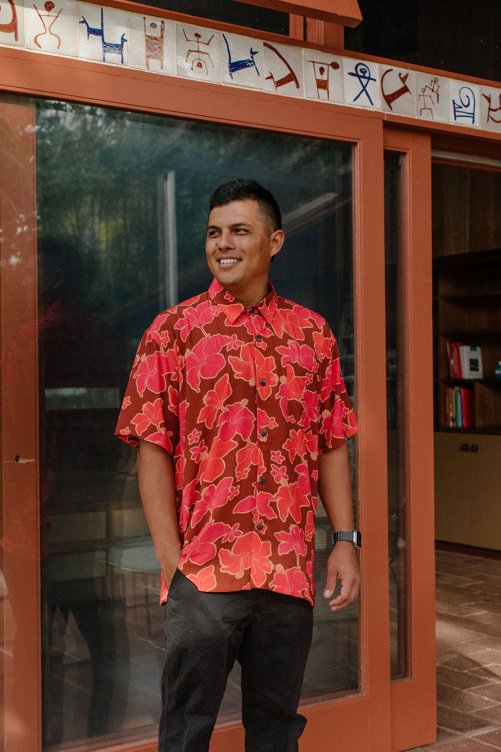 man wearing aloha shirt with vibrant pink pua pattern
