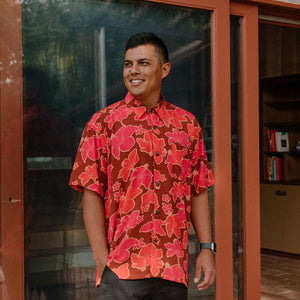 man wearing aloha shirt with vibrant pink pua pattern