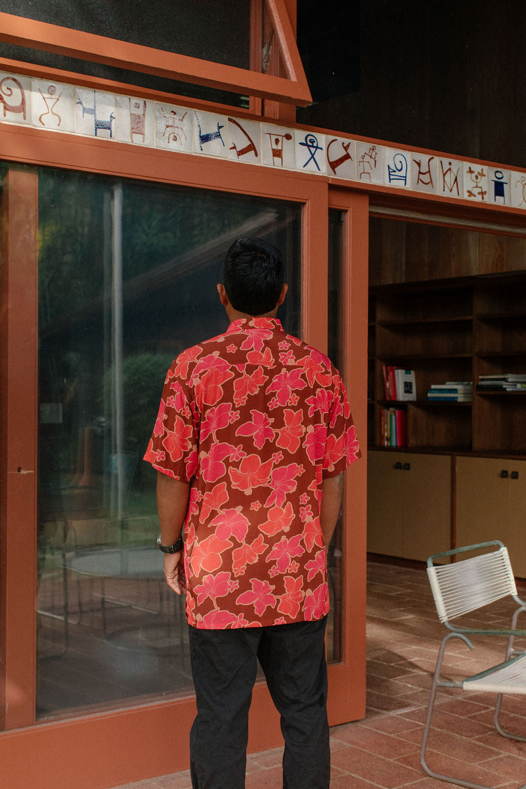man wearing aloha shirt with vibrant pink pua pattern
