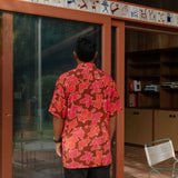 man wearing aloha shirt with vibrant pink pua pattern